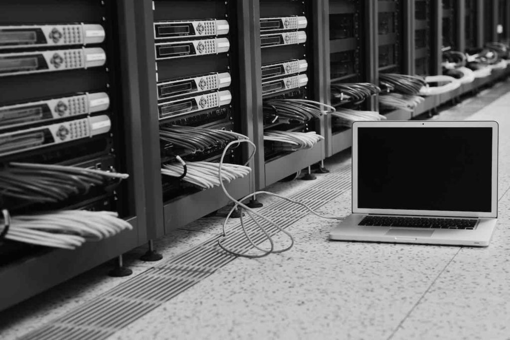 laptop connected to a bank of computer servers