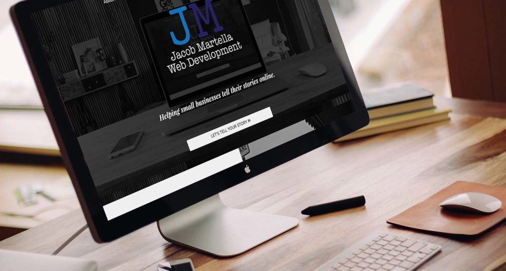 Jacob Martella website homepage on an iMac screen on a wooden desk