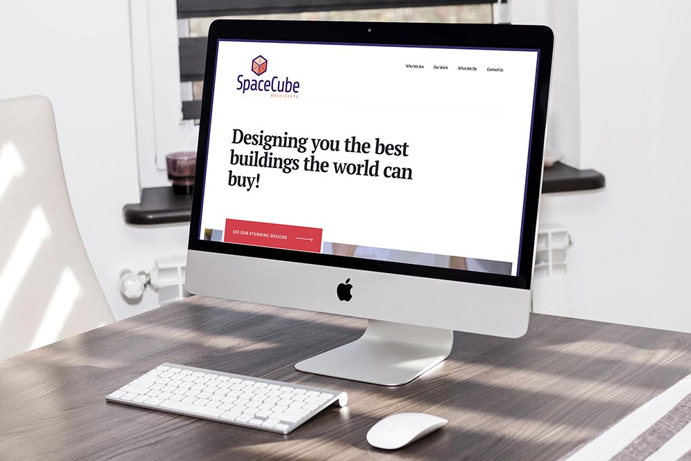 Homepage of a website on an iMac screen on a wood table