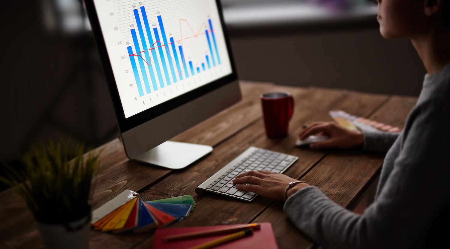 Woman looking at iMac screen about page speed for her site