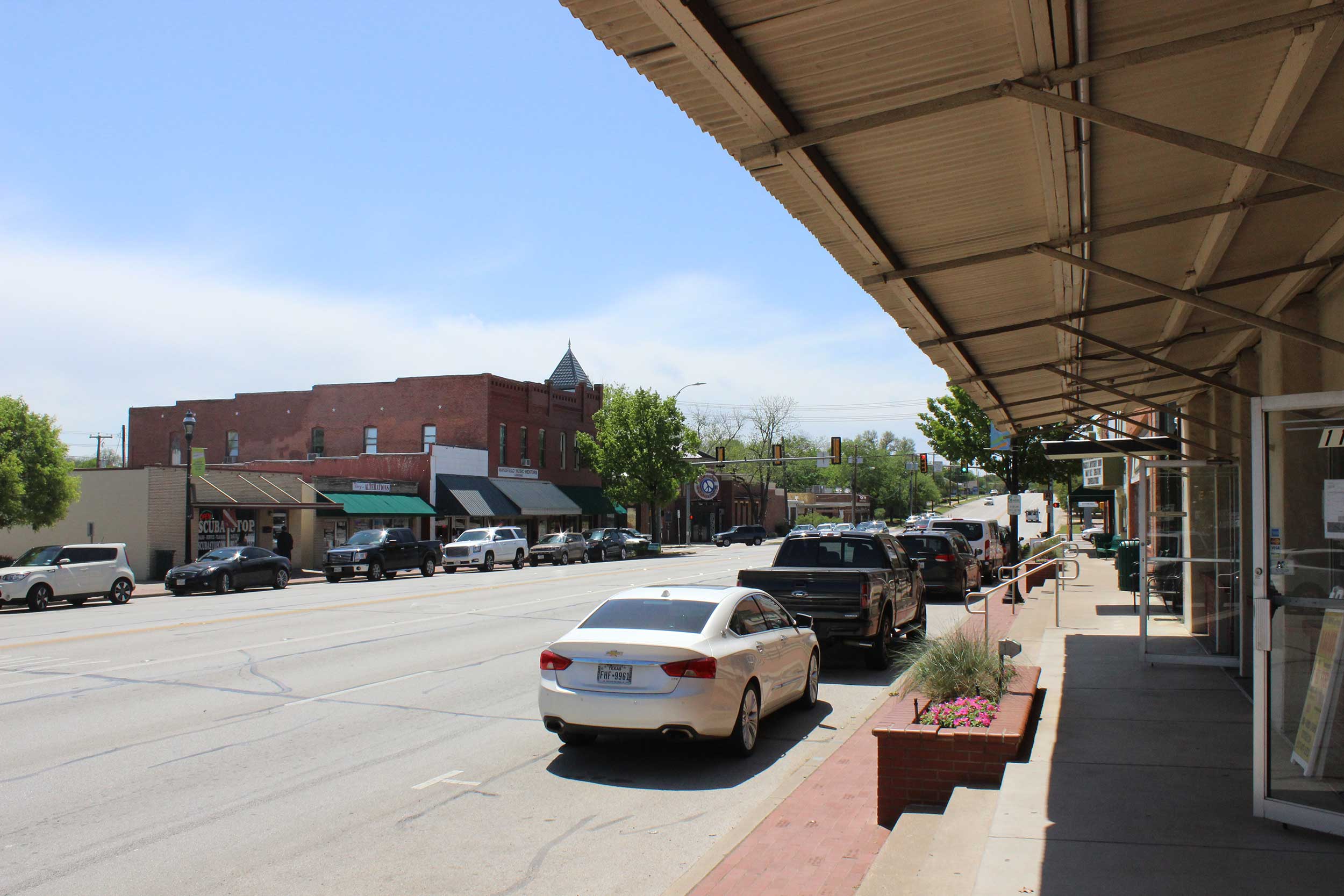 A small downtown street with businesses on both sides of the road