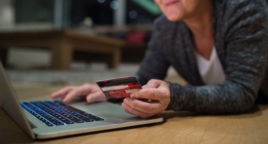 lady on a laptop using a credit card to make a purchase on an ecommerce website