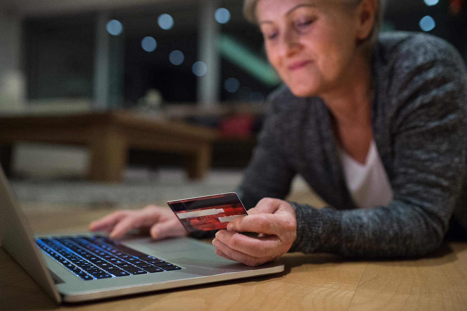 Woman on a laptop looking at her credit card